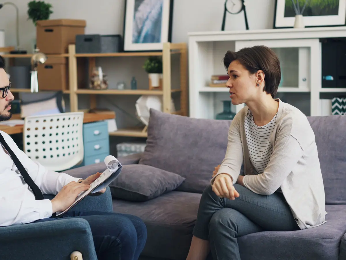 A therapist talking with a client in a calm office