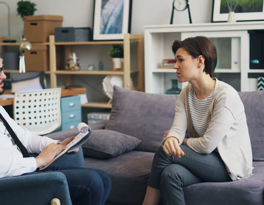 A therapist talking with a client in a calm office