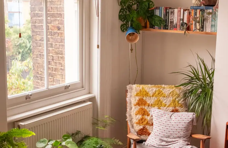 A sunny corner of a therapy room with an armchair and plants