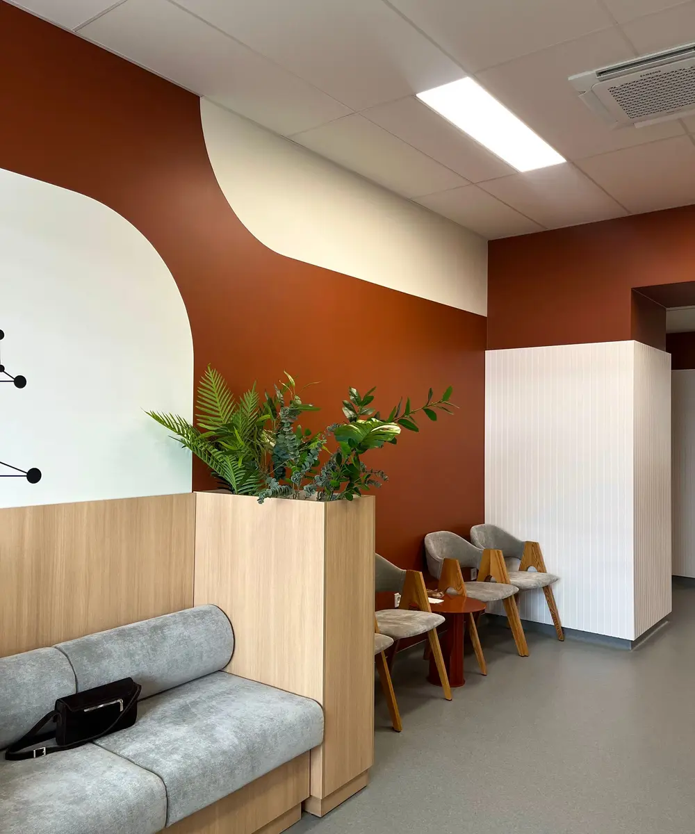 A warm, modern waiting room with plants